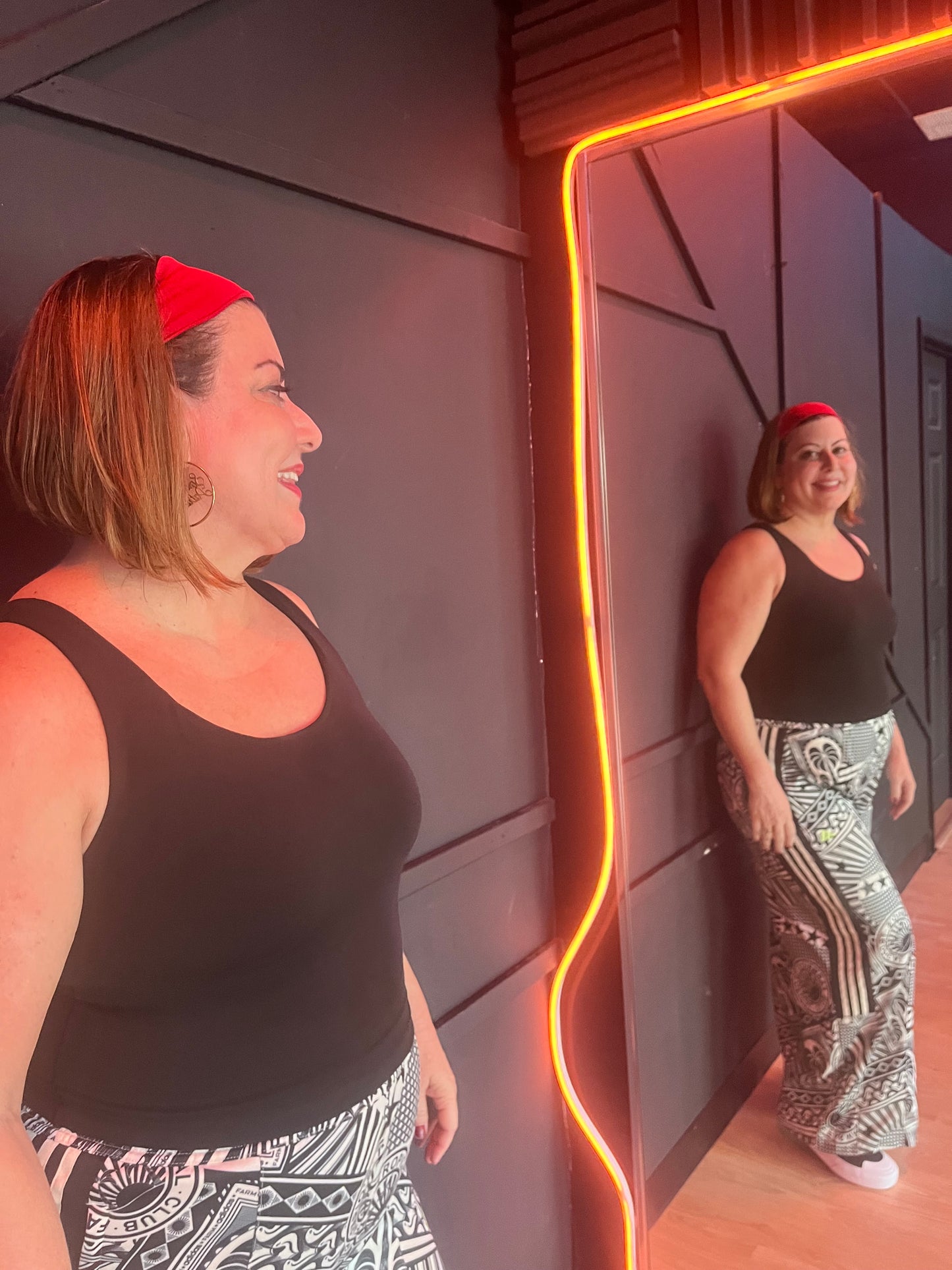 Woman wearing Scarlet Red Laze Headband during workout or errands - no-slip fit and bold style