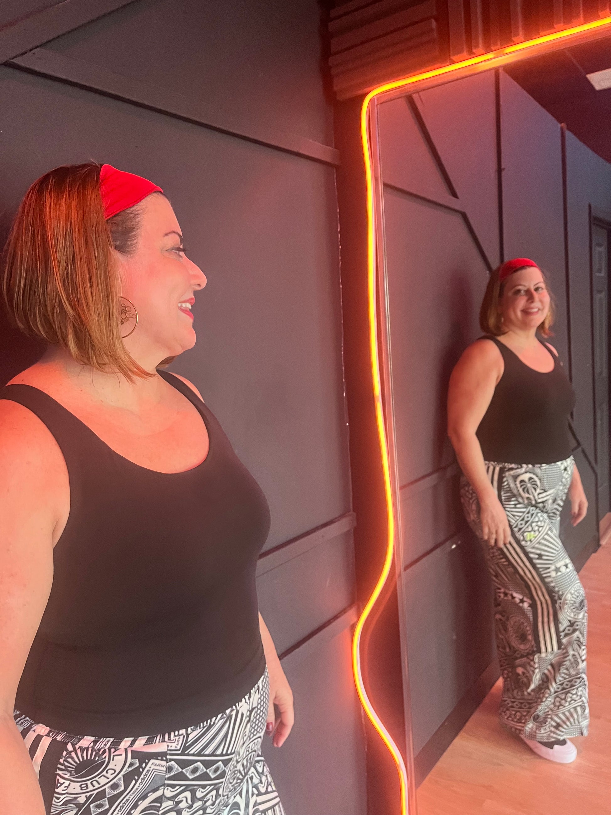 Woman wearing Scarlet Red Laze Headband during workout or errands - no-slip fit and bold style